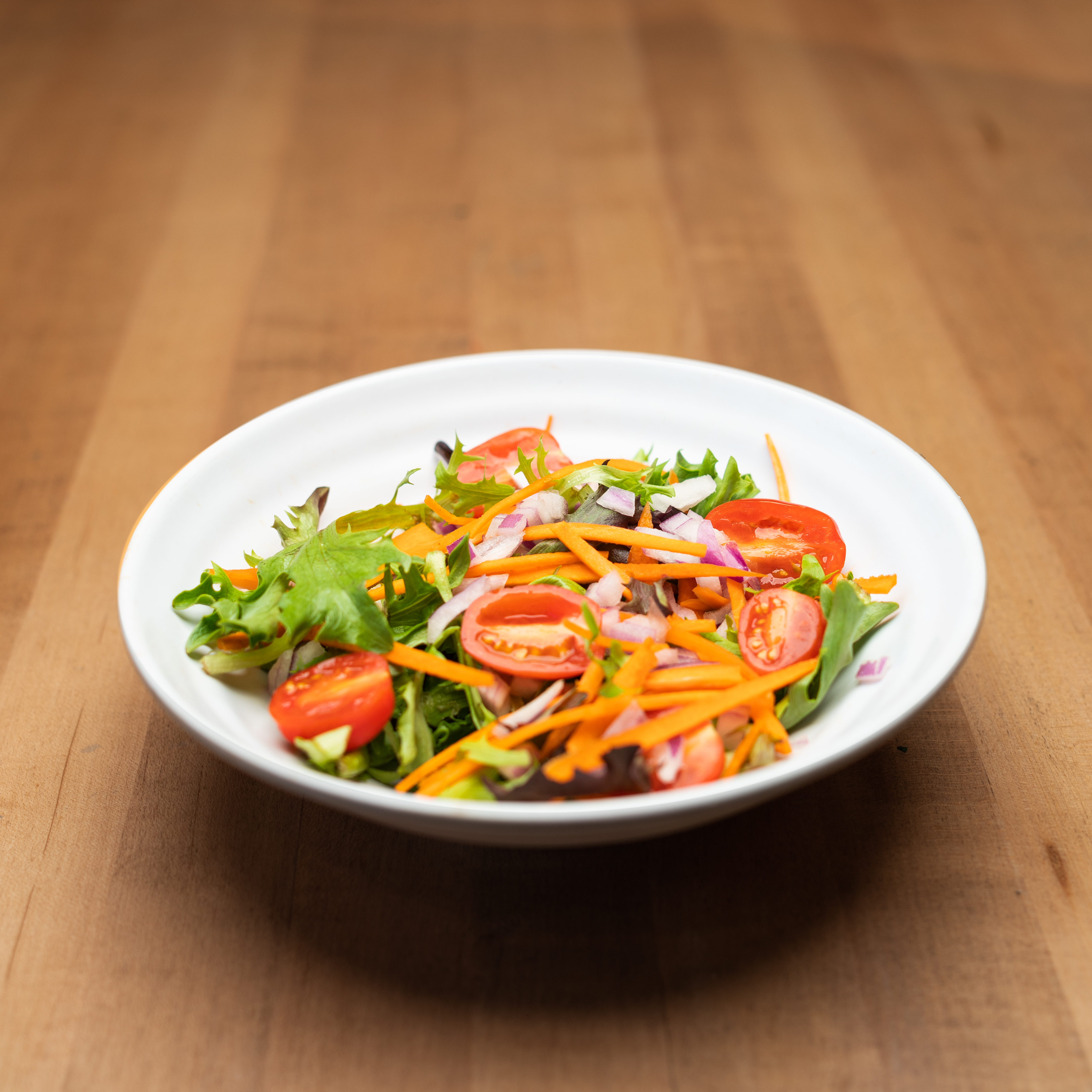 House Salad - Crisp mixed greens, red onions, shredded carrots &...